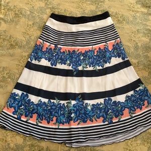 Patterned midi length skirt with elastic waist band. Fully lined.